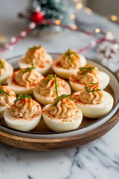 A photo of a  Christmas Deviled Eggs a christmas potluck recipes Devilled Eggs Christmas, Deviled Eggs Christmas, Christmas Potluck Recipes, Appetizer Wreath, Christmas Deviled Eggs, Christmas Potluck Dishes, Christmas Finger Food Ideas, Party Deviled Eggs, Potluck Christmas