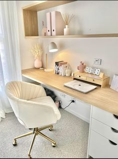 a white chair sitting in front of a wooden desk