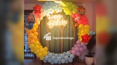 a birthday balloon arch with balloons and stars on it in the shape of a circle