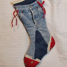 an old pair of jeans has been decorated with red, white and blue laces