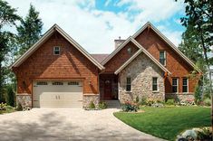 a large brick and stone house with two garages