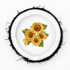 two sunflowers painted on the inside of a coconut shell