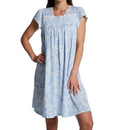 Soft, lightweight nightgown features lovely finishing touches and a classic pattern. Silkyknit fabric feels remarkably soft and light to the touch. Square neckline has a border of floral lace applique. Partial button closure at neck is topped off with a small bow and secures with 4 buttons. Smocking over bust is accented with shiny thread. Short cap sleeves with ruching at top and picot trim at openings. Hem and back of neck are trimmed with picot. Above-the-knee design. Pullover styling. Brande Elegant Light Blue Sleepwear For Loungewear, Blue Spring Nightgown For Overnight, Blue Relaxed Fit Nightgown For Bedtime, Blue Nightgown For Spring, Comfortable Blue Dresses For Loungewear, Casual Blue Nightgown For Relaxation, Blue Relaxed Fit Sleepwear For Overnight, Casual Blue Lace-trim Sleepwear, Casual Blue Sleepwear With Lace Trim