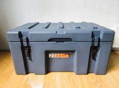 a large blue box sitting on top of a wooden floor