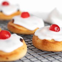 small pastries with cherry toppings on a white plate