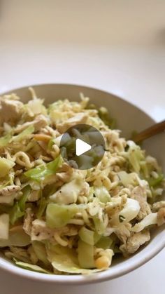 a white bowl filled with food on top of a table