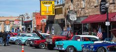 many classic cars are parked on the street