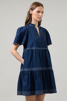 From casual outings to evening occasions, the Betty Poplin Tiered Mini Dress is the right one! A split neckline with ruffle trim frames short sleeves with inverted pleats on shoulders. Two tiers on the bodice with outline enhance a loose fit on the dress. Wear it with strappy heels and gold accessories to match. - Tiered- V-neck- Puffed short sleeves- Ruffle trim- Comes in 2 colorsSize + Fit - Model is 5'8" and wearing size XS- Measurements taken from size S - Chest: 19 3/4"- Length: 36" Fabric Short Sleeve Styles For Dresses, Crazy Clothes, Tier Dress, Tiered Mini Dress, Crazy Outfits, Poplin Dress, Open Back Dresses, Daily Style, Dress Silhouette