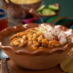 a bowl filled with food sitting on top of a wooden table