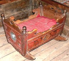 an old wooden bed sitting on top of a wooden floor