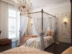 a bedroom with a four poster bed and chandelier hanging from it's ceiling