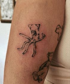 a woman with a tattoo on her arm has an octopus and dog design on it