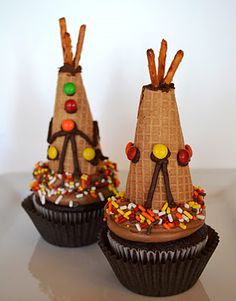 three cupcakes decorated with chocolate frosting and candy