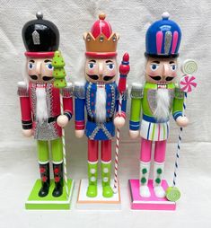 three wooden nutcrackers are standing next to each other