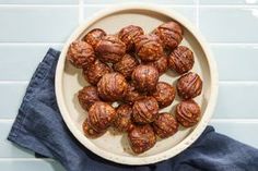 a bowl filled with nuts sitting on top of a blue counter next to a pair of jeans