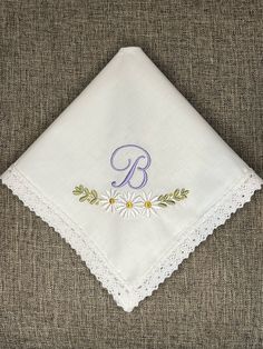 "White Daisy monogram machine embroidered wedding handkerchief. The example handkerchief was embroidered on a 100% cotton scalloped women's white handkerchief, it measures 11\" by 11\".  You may also upgrade to a 100% cotton lace women's white handkerchief that measures 11.5\" by 11.5\", shown in the third photo.    The product is made in a smoke free home." Handmade White Handkerchiefs For Gift, White Handmade Handkerchief As Gift, White Wedding Handkerchiefs, Elegant White Handkerchiefs For Bridal Shower, Handmade White Wedding Handkerchiefs, Embroidered White Handkerchiefs For Bridesmaids, Customizable White Handkerchiefs For Anniversary, Personalized White Handkerchiefs For Special Day, White Embroidered Handkerchiefs For Bridesmaid Gift