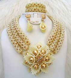 PrestigeApplause Customised Cream White with Gold Crystal Bridal Wedding African Bead Jewellery Set UK Fast Delivery Complete Set is Necklace Earring and bracelet Wedding, Party, Bridal, Special Occasion This detailed Jewellery set makes you stand out elegantly in any special occassion, it's all about glamour and uniqueness.  Handmade to perfcetion. Please not good accesories might not be exact but would be similar.  Buying more that 2 Jewellery set, we offer wholesale and bulk prices for all ou Hand Fans For Wedding, Wedding Fans, Bracelet Wedding, Gold Feathers, Detailed Jewelry, African Beads, Gold Crystal, Jewellery Set, Coral Beads