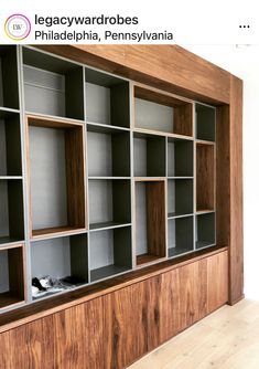 an empty bookcase with wooden shelves on the wall