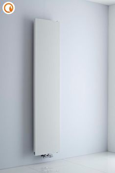 a white radiator mounted to the side of a wall in an empty room