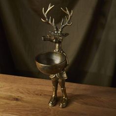 a metal bowl with a deer head on it