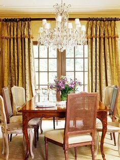 a dining room table with chairs and a chandelier