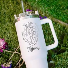 a white coffee mug sitting in the grass