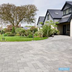 an empty driveway in front of a house