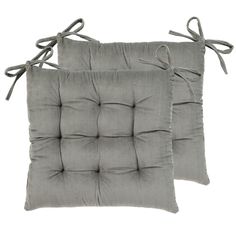 two gray cushions with ties on the sides and one has a square cushion in the middle