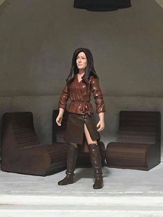 the action figure is dressed in brown leather