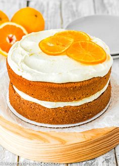 there is a cake with oranges on the top and frosting in the middle