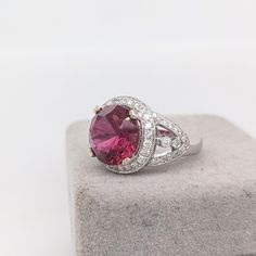 Presenting NNJ Designs' Summer Collection! This beautiful estate ring features a 5.76 carat round pink tourmaline gemstone with a halo of natural earth mined diamonds and milgrain detail with a split shank, all set in solid 14K gold. This ring is made with solid 14K Gold and natural Earth mined SI / G-H diamonds. As listed, this ring is ready to ship. If you're interested in purchasing this setting with a different center stone please message us! Designer Silver Jewellery, Estate Ring, Estate Rings, Pink Tourmaline Ring, Jewelry Showcases, Tourmaline Ring, Split Shank, Tourmaline Gemstone, Natural Earth