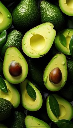 avocados with leaves and one cut in half