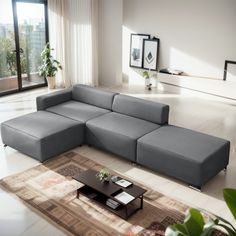 a living room with a sectional couch and coffee table in the middle, on top of a rug