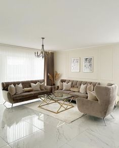 a living room filled with furniture and a chandelier