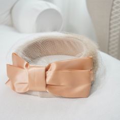 This Is An Incredible Vintage Pillbox Hat. It Features A Beige Velveteen Base Encircled In A Band Of Fur. There’s Also A Matching Birdcage Veil/Netting That Drapes Beautifully Over It, With A Silky Pink Bow In The Back. This Style Pillbox Hat Is Very Reminiscent Of The Jackie Kennedy Style. Color - Beige & Salmon Pink Other Birdcage Veil Hats/Fascinators On My Posh Closet - Open To Reasonable Offers - Veiled Hats, Bridal Hat, Birdcage Veil, Pillbox Hat, Salmon Pink, Pill Boxes, Bird Cage, Pink Bow, Hats Vintage