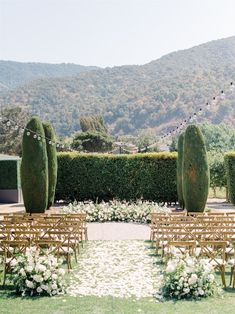 an outdoor ceremony set up with chairs and flowers