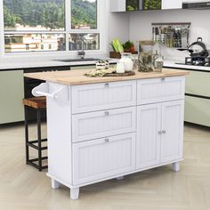 a white kitchen with an island in the middle