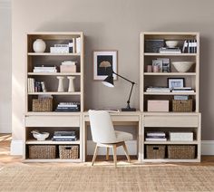 a white chair sitting in front of a book shelf filled with books and other items