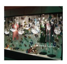 a display case filled with lots of different types of christmas ornament hanging from it's sides