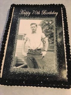 a black and white photo of a man on a birthday cake