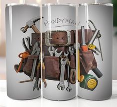 three stainless steel mugs with different tools on them