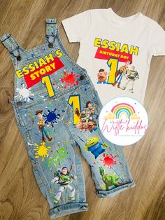 a pair of children's clothing and stickers on a wooden floor