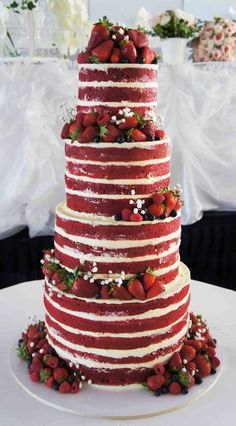 a three layer cake with strawberries on top