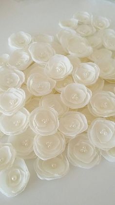 a pile of white buttons sitting on top of a table