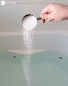 a person is sprinkling sugar on top of a bathtub