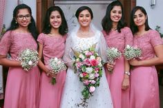 the bride and her bridesmaids are all wearing pink dresses