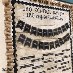 a bulletin board is decorated with black and white paper streamers that spell out the school days