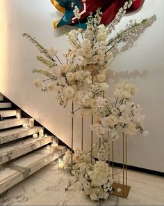 flowers and candles are on the floor in front of stairs