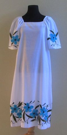 "This is a great vintage muumuu dress in a bright clean white with simple floral details on the sleeves and the hem made from individual applique flowers and embroidered leaves. The mannequin measures Bust = 33\" Waist = 24\" Hips = 34\" Measurements are approx. and taken with the dress laying flat Bust = underarm to underarm = 20\" Length = from shoulder to hem = 44\" I think this dress would look cute with a matching sash tied around the waist to give it a more fitted look. In great vintage co Moomoo Dress Muumuu, Muumuu Dress Pattern, Moomoo Dress, Island Style Clothing, Hawaiian Muumuu, Applique Flowers, Dragon Heart, Muumuu Dress, Costura Fashion