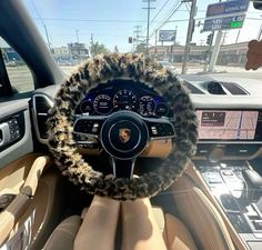 the interior of a car with a steering wheel covered in faux fur and fuzzy trim